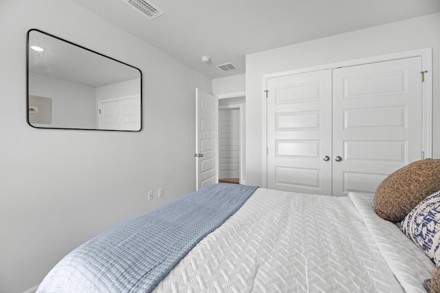 bedroom with a closet and visible vents