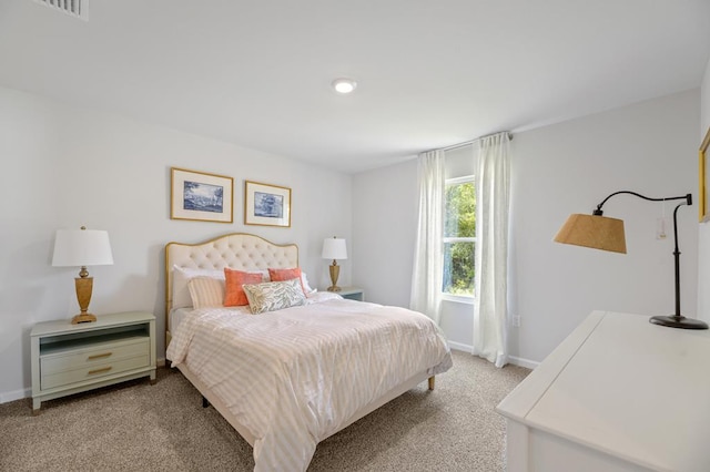 bedroom featuring light carpet and baseboards