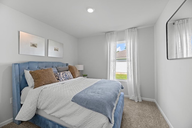 carpeted bedroom featuring baseboards