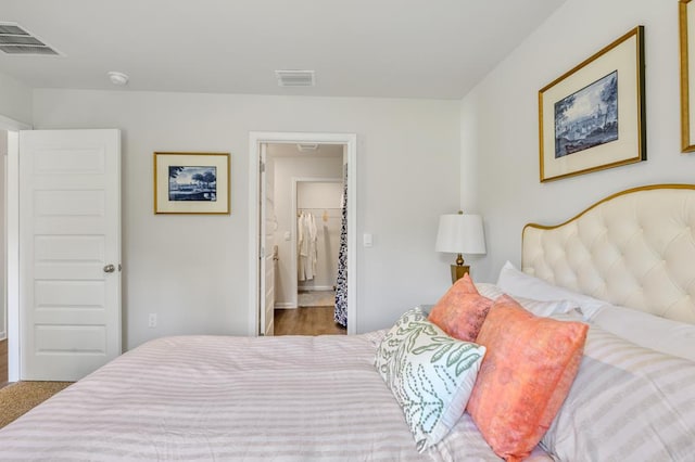 bedroom featuring visible vents and wood finished floors