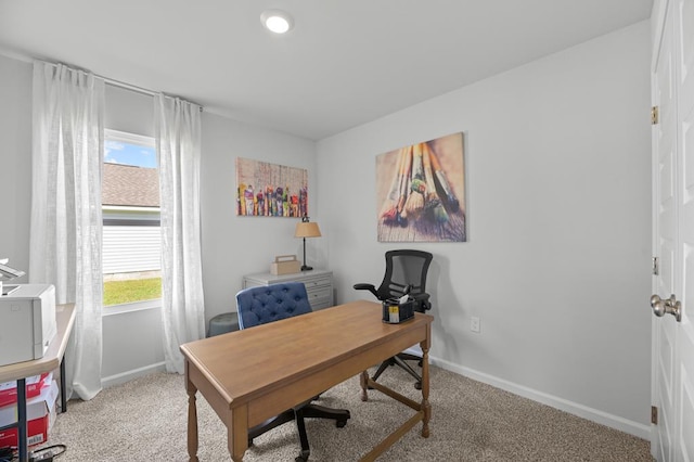 carpeted home office featuring baseboards