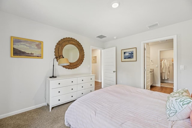 bedroom with carpet flooring, visible vents, and baseboards