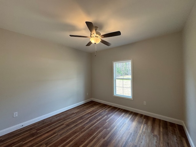 empty room with ceiling fan, baseboards, and dark wood-style flooring