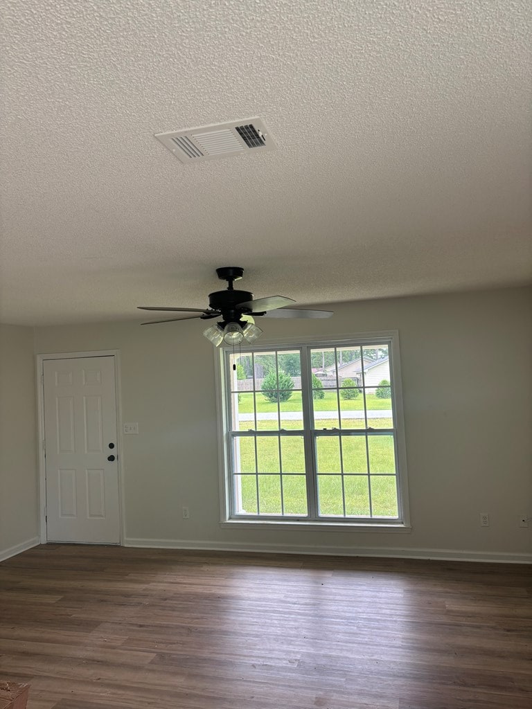 1000 E Gate Dr, Bainbridge, GA 39817 - empty room featuring a textured ceiling, ceiling fan, and dark wood-style floors
