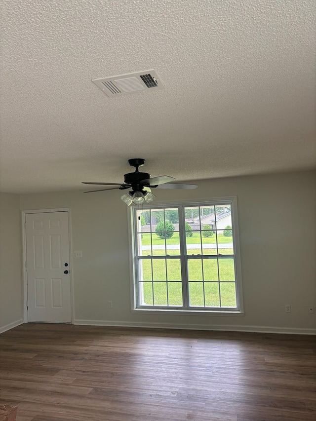 1000 E Gate Dr, Bainbridge, GA 39817 - empty room featuring a textured ceiling, ceiling fan, and dark wood-style floors