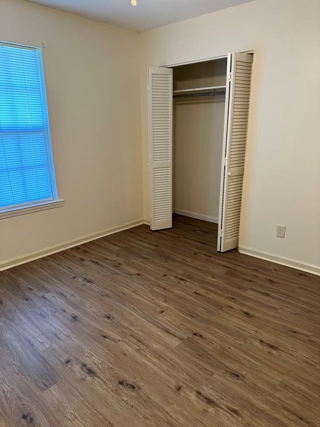 unfurnished bedroom featuring dark wood-type flooring