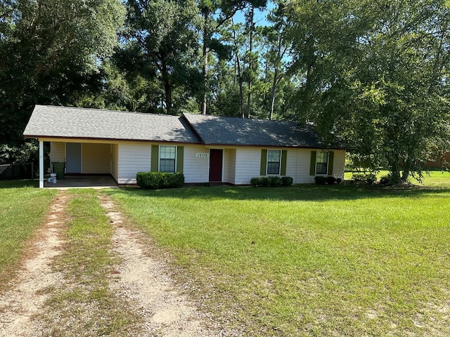 single story home featuring a carport and a front lawn