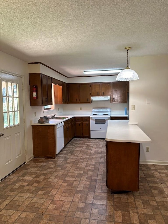 kitchen with sink, kitchen peninsula, pendant lighting, a textured ceiling, and white appliances