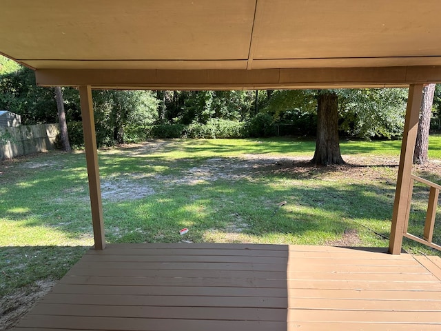 wooden terrace with a lawn