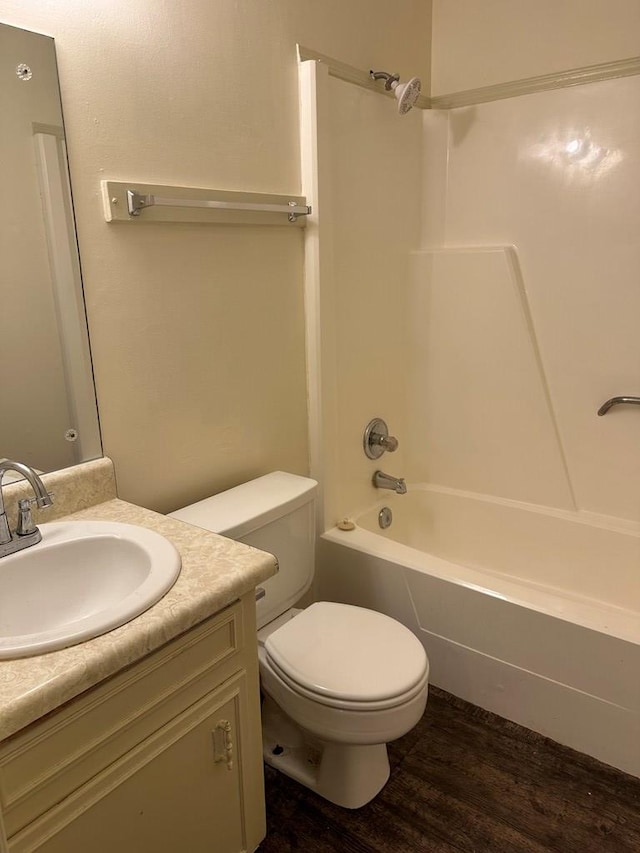 full bathroom with vanity, hardwood / wood-style flooring, toilet, and shower / bathtub combination