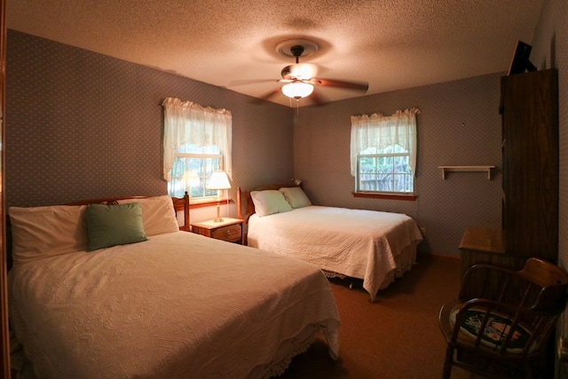 407 Lakeshore Dr, Bainbridge, GA 39819 - carpeted bedroom with a ceiling fan and a textured ceiling