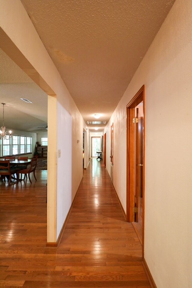 407 Lakeshore Dr, Bainbridge, GA 39819 - hallway with wood-type flooring and a chandelier