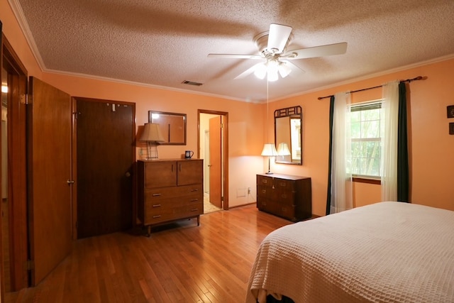 407 Lakeshore Dr, Bainbridge, GA 39819 - bedroom with crown molding, a textured ceiling, visible vents, and wood finished floors