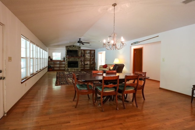 407 Lakeshore Dr, Bainbridge, GA 39819 - dining area featuring vaulted ceiling, wood finished floors, ceiling fan with notable chandelier, and a fireplace