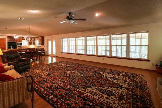 407 Lakeshore Dr, Bainbridge, GA 39819 - living area with visible vents, a textured ceiling, a ceiling fan, wood finished floors, and vaulted ceiling
