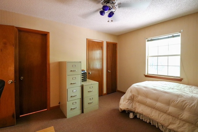 407 Lakeshore Dr, Bainbridge, GA 39819 - carpeted bedroom with ceiling fan, wallpapered walls, and a textured ceiling