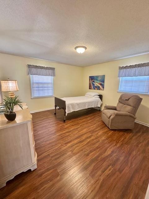 bedroom featuring dark wood-type flooring and a textured ceiling