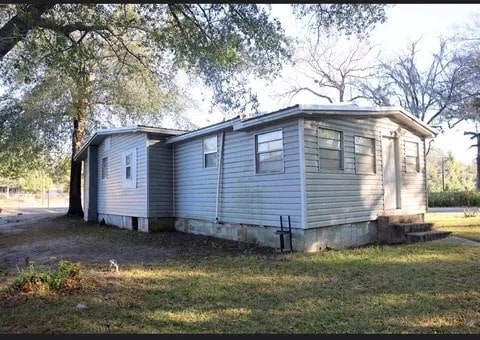 view of property exterior with a lawn