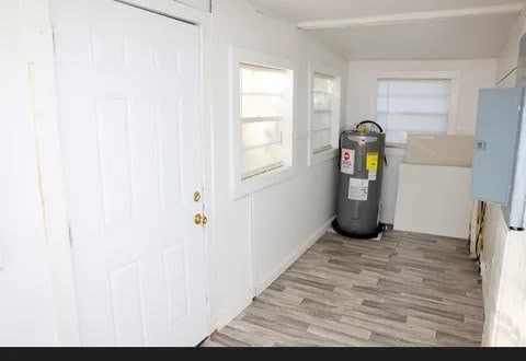 utility room featuring water heater