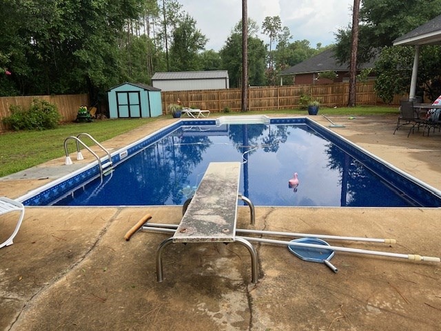1002 Willis St, Bainbridge, GA 39819 - view of pool with a storage shed, a fenced backyard, a diving board, and a patio