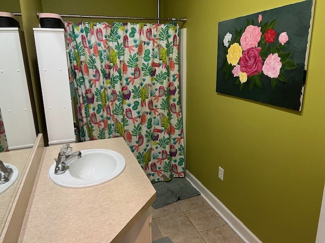 1002 Willis St, Bainbridge, GA 39819 - bathroom with vanity, tile patterned floors, and curtained shower