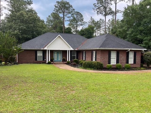 1002 Willis St, Bainbridge, GA 39819 - ranch-style home featuring french doors, brick siding, a front lawn, and a shingled roof