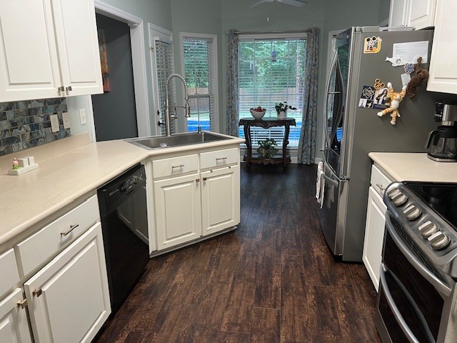 1002 Willis St, Bainbridge, GA 39819 - kitchen featuring dishwasher, electric stove, dark wood finished floors, a peninsula, and white cabinetry