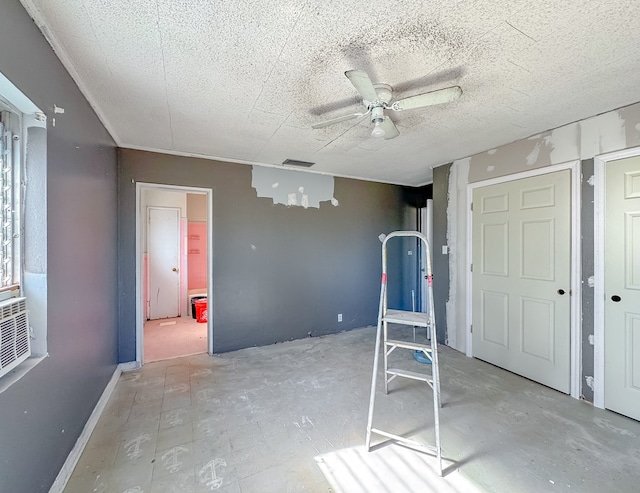 interior space with ceiling fan