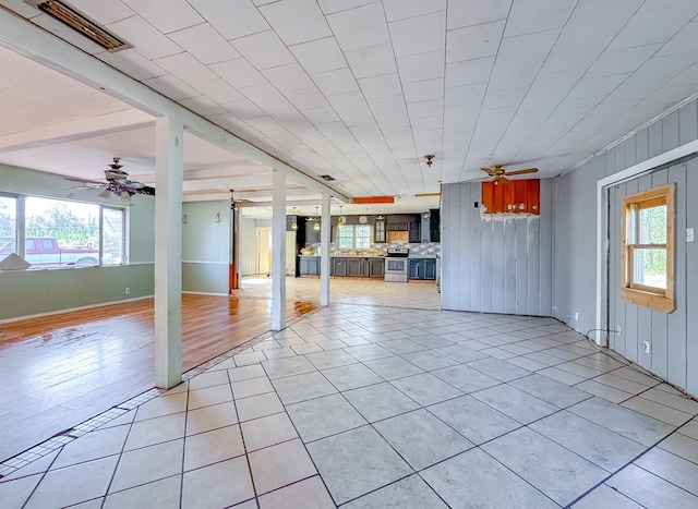 interior space featuring ceiling fan and light tile patterned floors