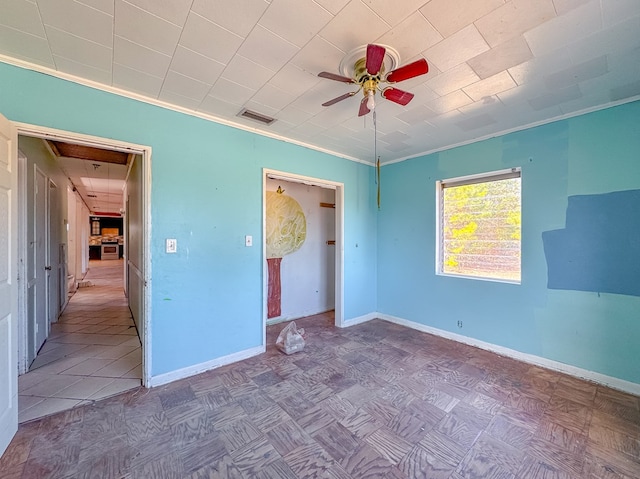 unfurnished bedroom featuring ornamental molding, ceiling fan, and parquet floors