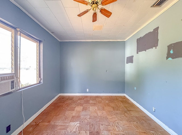 spare room with ceiling fan, light parquet floors, ornamental molding, and cooling unit