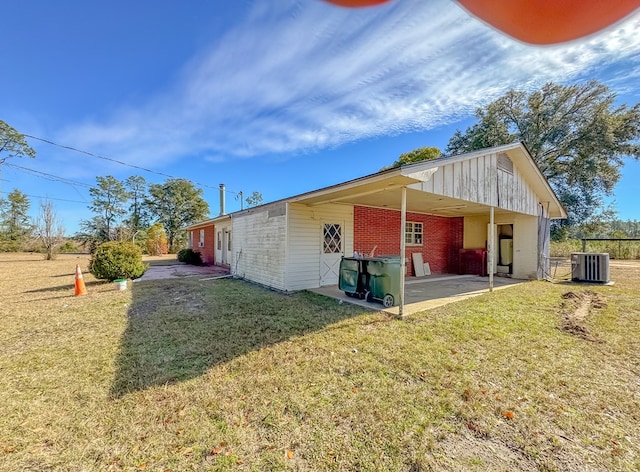 view of home's exterior featuring a patio, central AC unit, and a yard