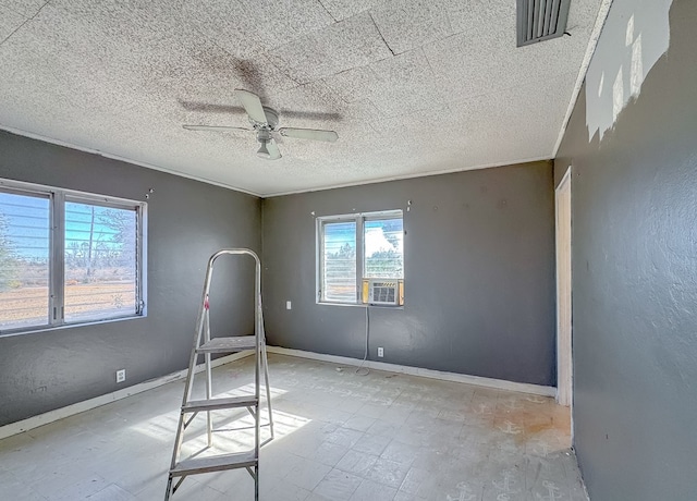 unfurnished room featuring cooling unit and ceiling fan