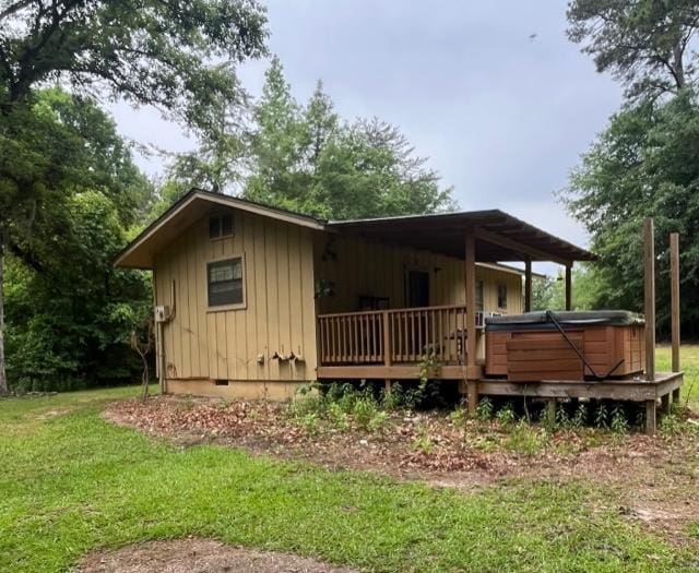 267 Providence Rd, Whigham, GA 39897 - view of home's exterior with a hot tub, board and batten siding, crawl space, and a lawn