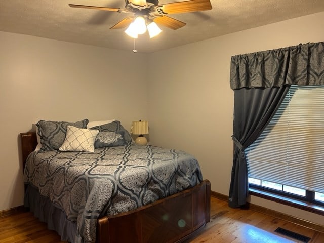 bedroom featuring light hardwood / wood-style floors and ceiling fan