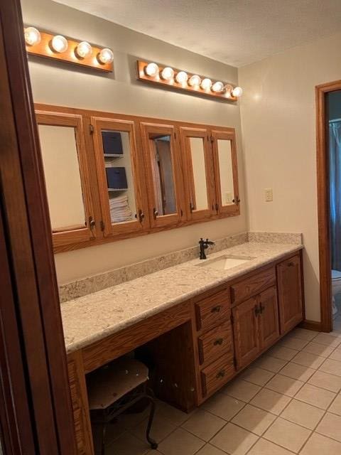 bathroom featuring tile patterned flooring, vanity, and toilet