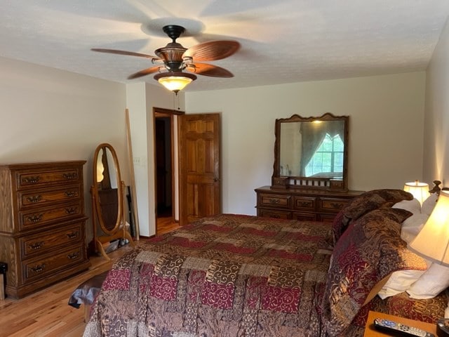 bedroom with light wood-type flooring and ceiling fan