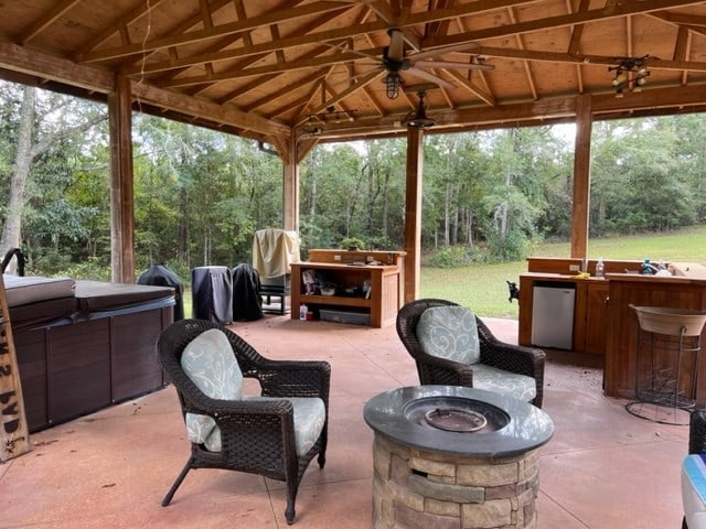 view of patio / terrace featuring a gazebo, an outdoor fire pit, and exterior bar