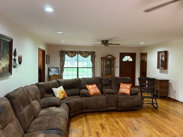 living room with light hardwood / wood-style flooring and ceiling fan