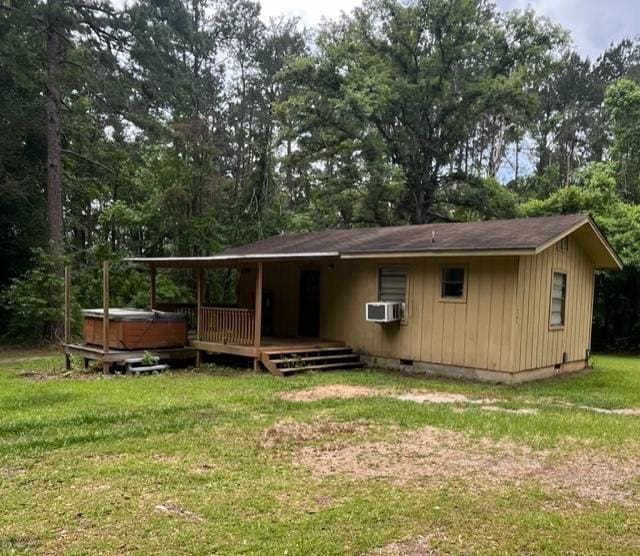 267 Providence Rd, Whigham, GA 39897 - back of house featuring a hot tub, crawl space, a wooden deck, a yard, and view of scattered trees
