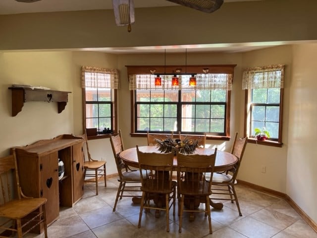 tiled dining space with a healthy amount of sunlight