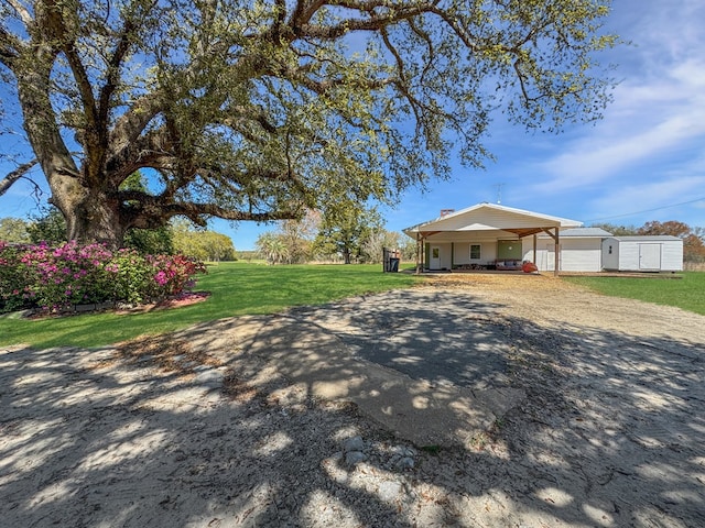 810 Three Notch Rd, Colquitt, GA 39837 - exterior space featuring a carport, driveway, an outdoor structure, and a front lawn