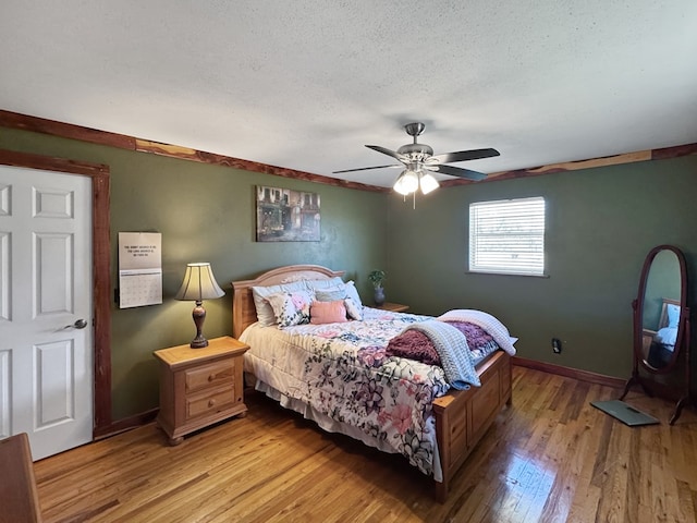 810 Three Notch Rd, Colquitt, GA 39837 - bedroom featuring ceiling fan, a textured ceiling, light wood-type flooring, and baseboards