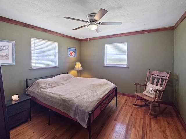810 Three Notch Rd, Colquitt, GA 39837 - bedroom featuring a textured ceiling, wood finished floors, crown molding, baseboards, and ceiling fan
