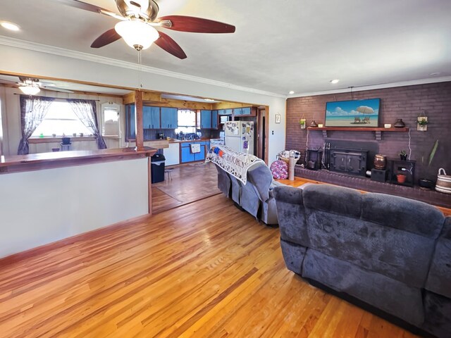 810 Three Notch Rd, Colquitt, GA 39837 - living area with brick wall, a fireplace, ceiling fan, crown molding, and light wood-type flooring