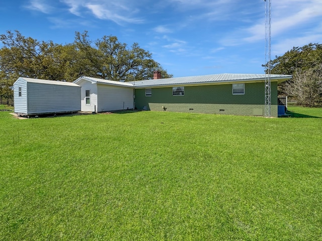 810 Three Notch Rd, Colquitt, GA 39837 - rear view of house featuring an outbuilding, metal roof, a lawn, and crawl space
