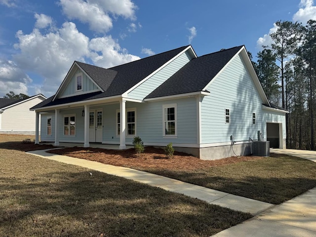 view of front of home featuring covered porch, central AC, roof with shingles, a front lawn, and board and batten siding