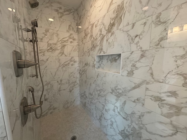 full bathroom featuring tiled shower