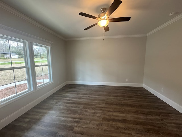 spare room with dark wood-style floors, ornamental molding, baseboards, and ceiling fan