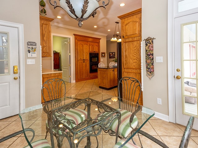 dining space with crown molding and light tile patterned flooring